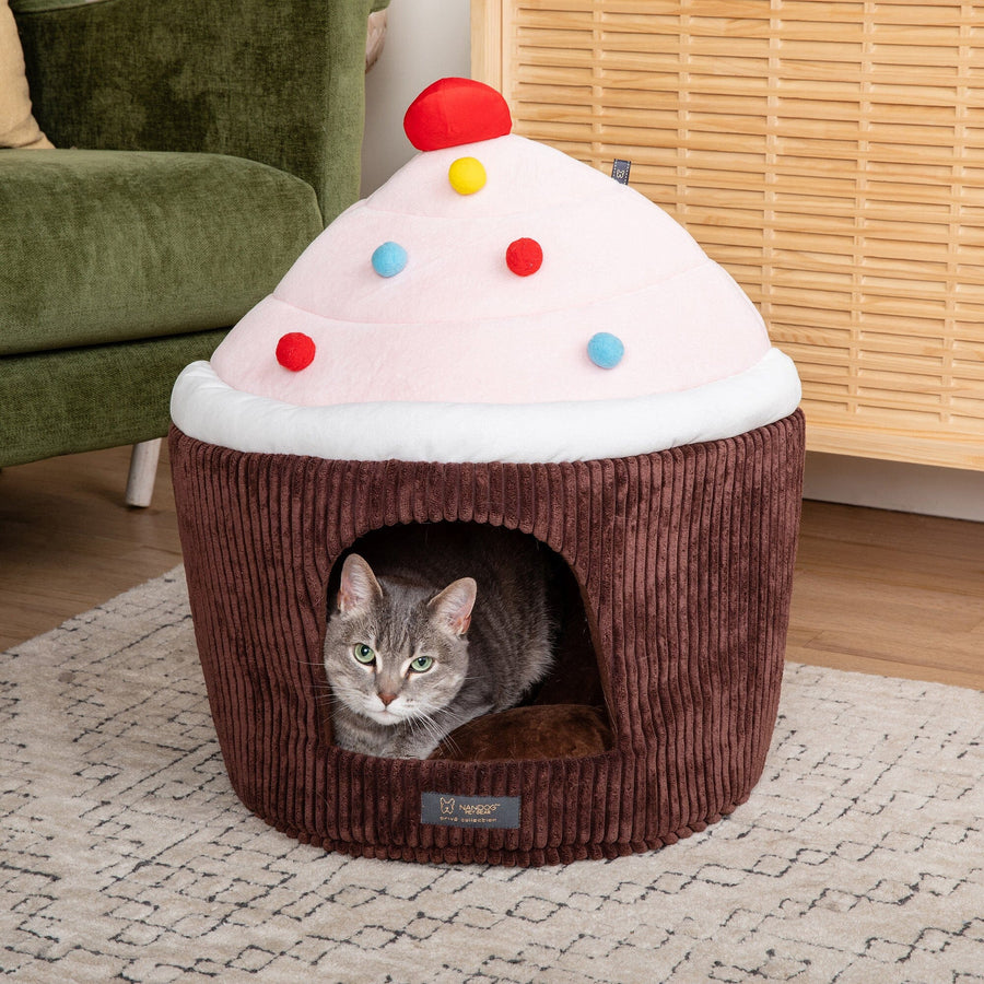 Cat peeking out of a Nandog chocolate cupcake cat hut